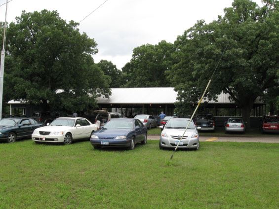 Cars parked in lot for large picnic shelter