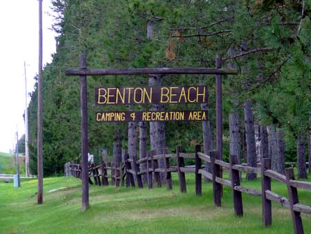 Wooden sign with Benton Beach camping and recreation area